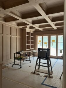 White oak shelving, walls, millwork, and beams come together in a custom library. Built by JPC.